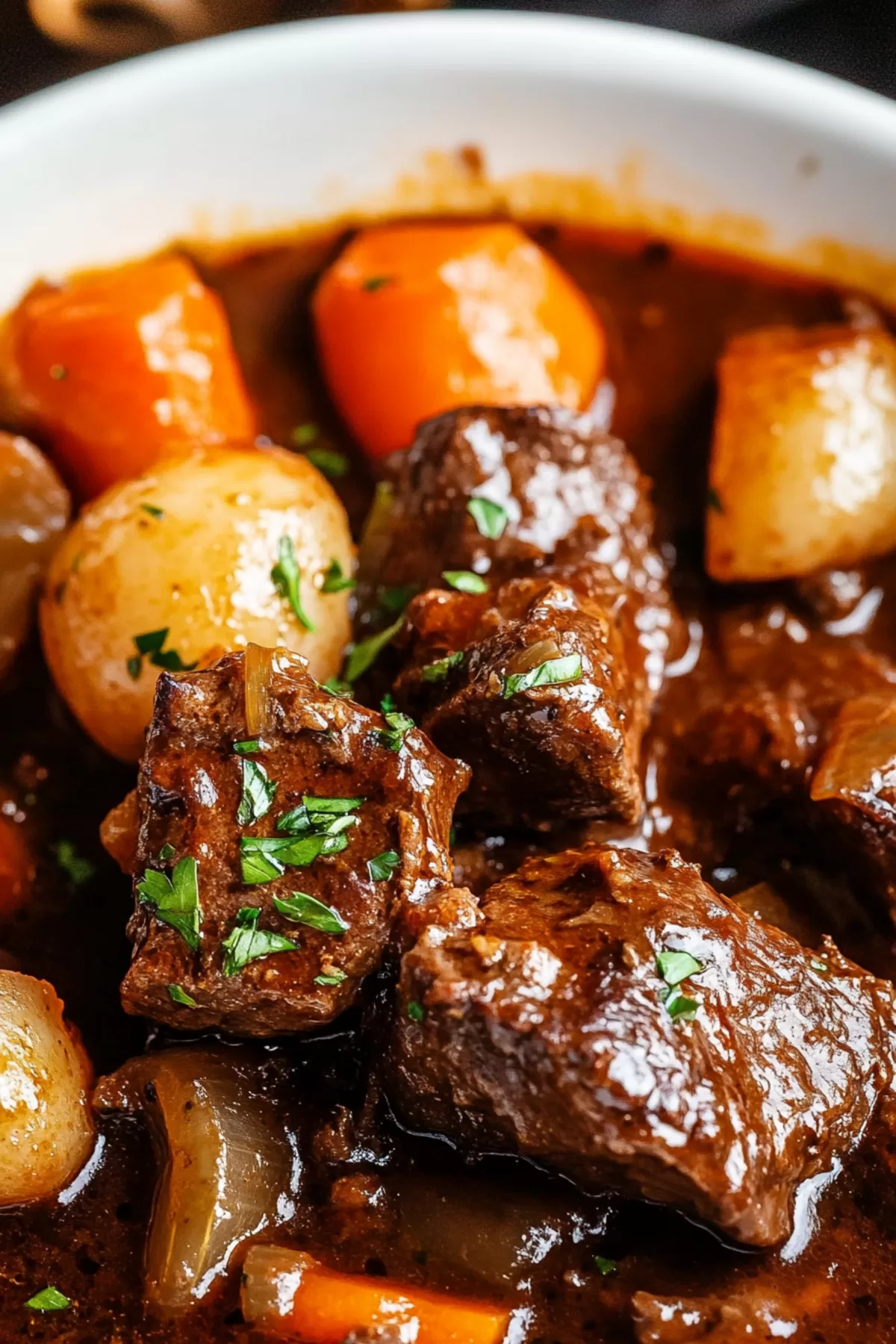 Close-up of a comforting dish featuring slow-cooked beef and a savory red wine glaze.