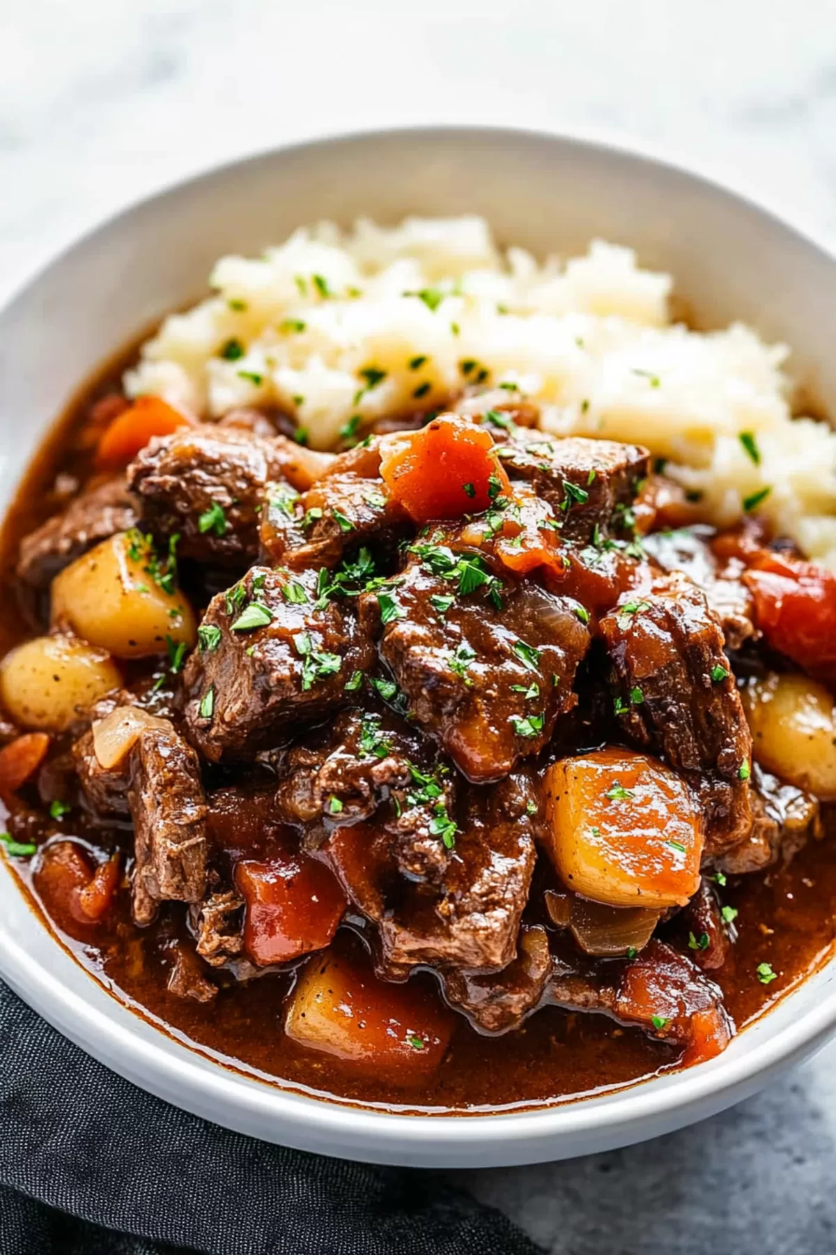 A rustic serving of stew paired with crusty bread, perfect for a cozy meal.