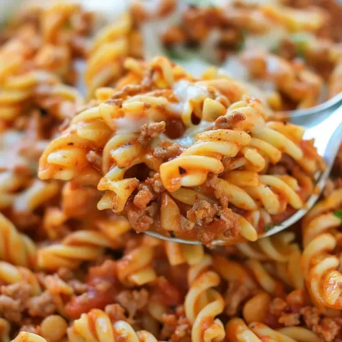 Savory and Cheesy Pasta Dish: A comforting pasta dish with a creamy cheese sauce, mixed with seasoned ground beef and sprinkled with fresh herbs.