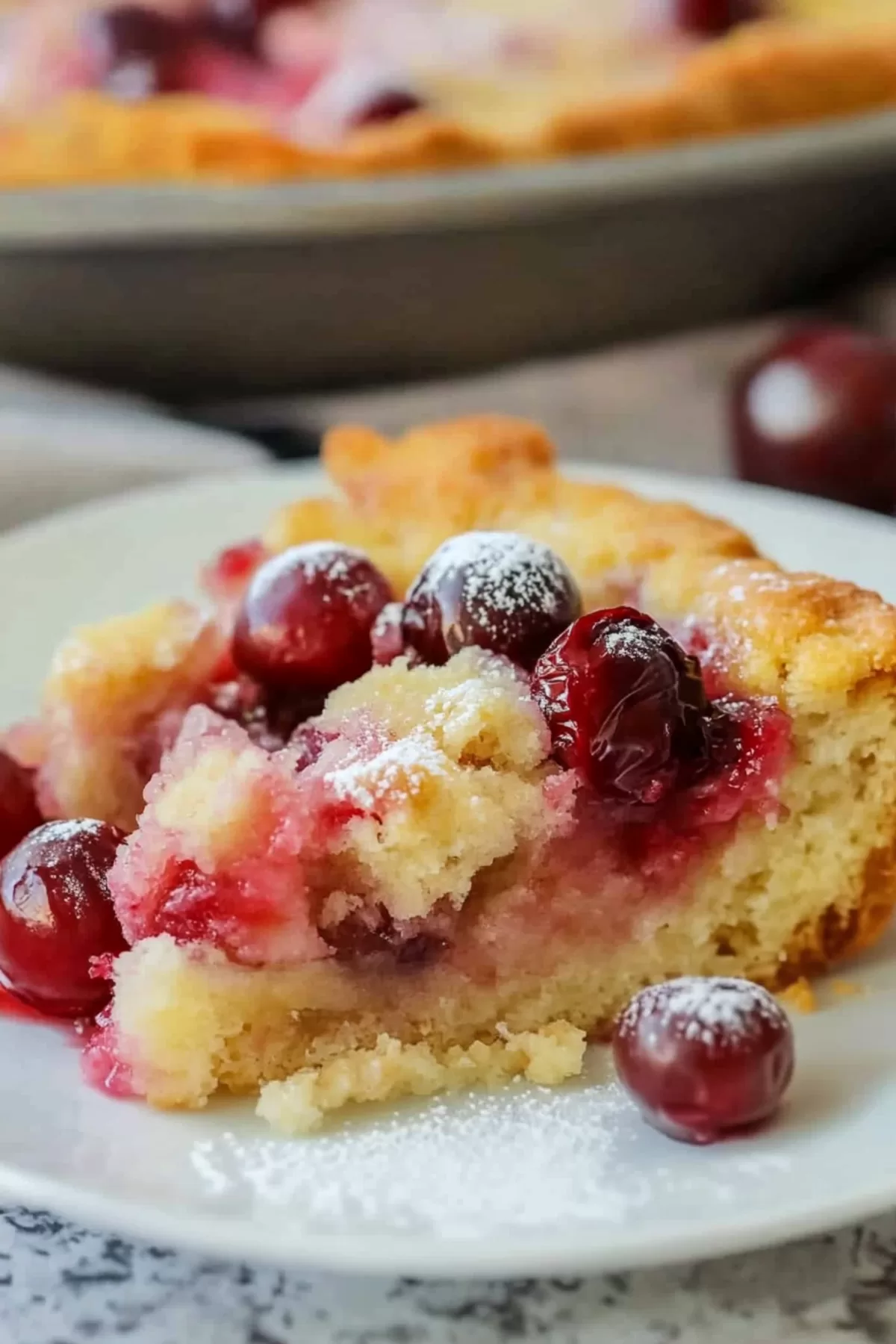 A side view of cherry dump cake, showing the layers of sweet cherries and buttery crust.