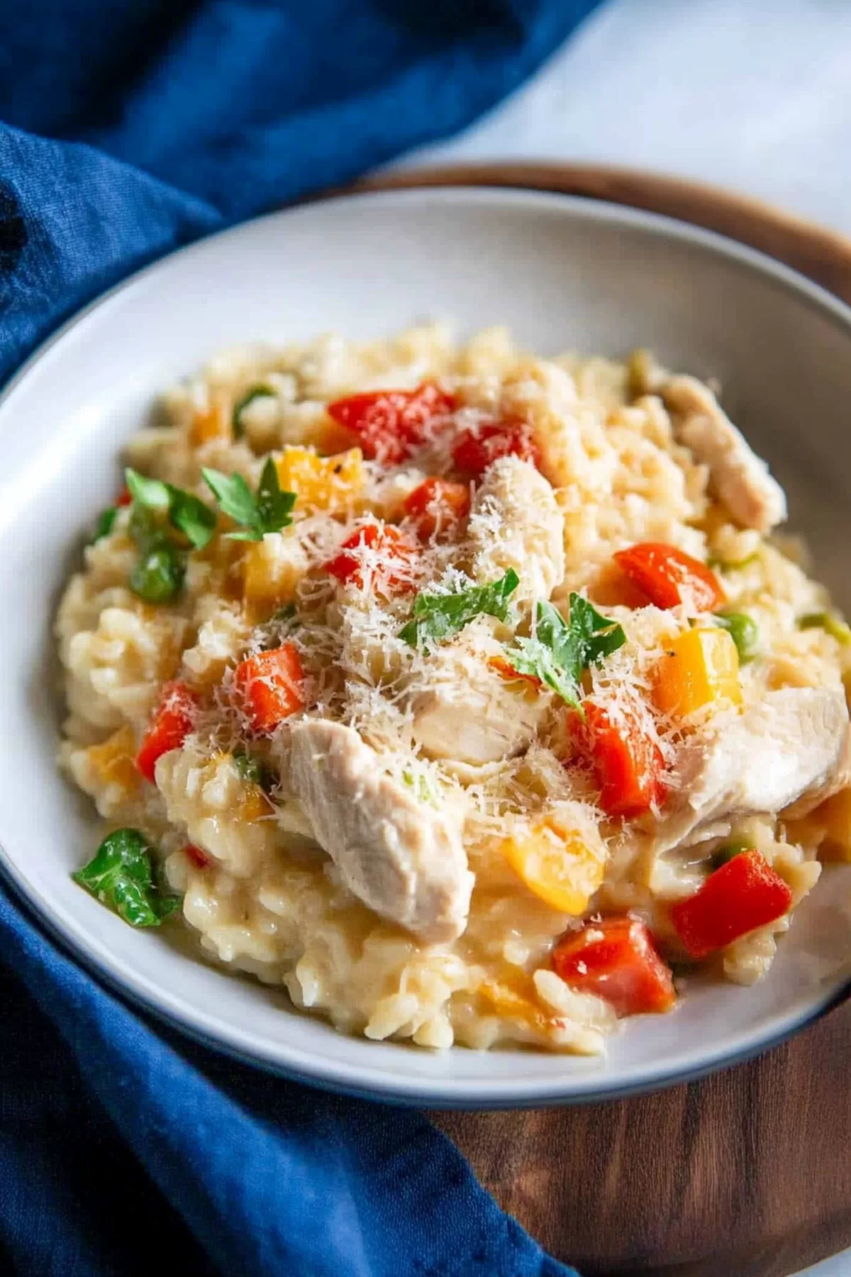 A comforting dish of risotto loaded with chicken, peas, and bell peppers, ready to be served.