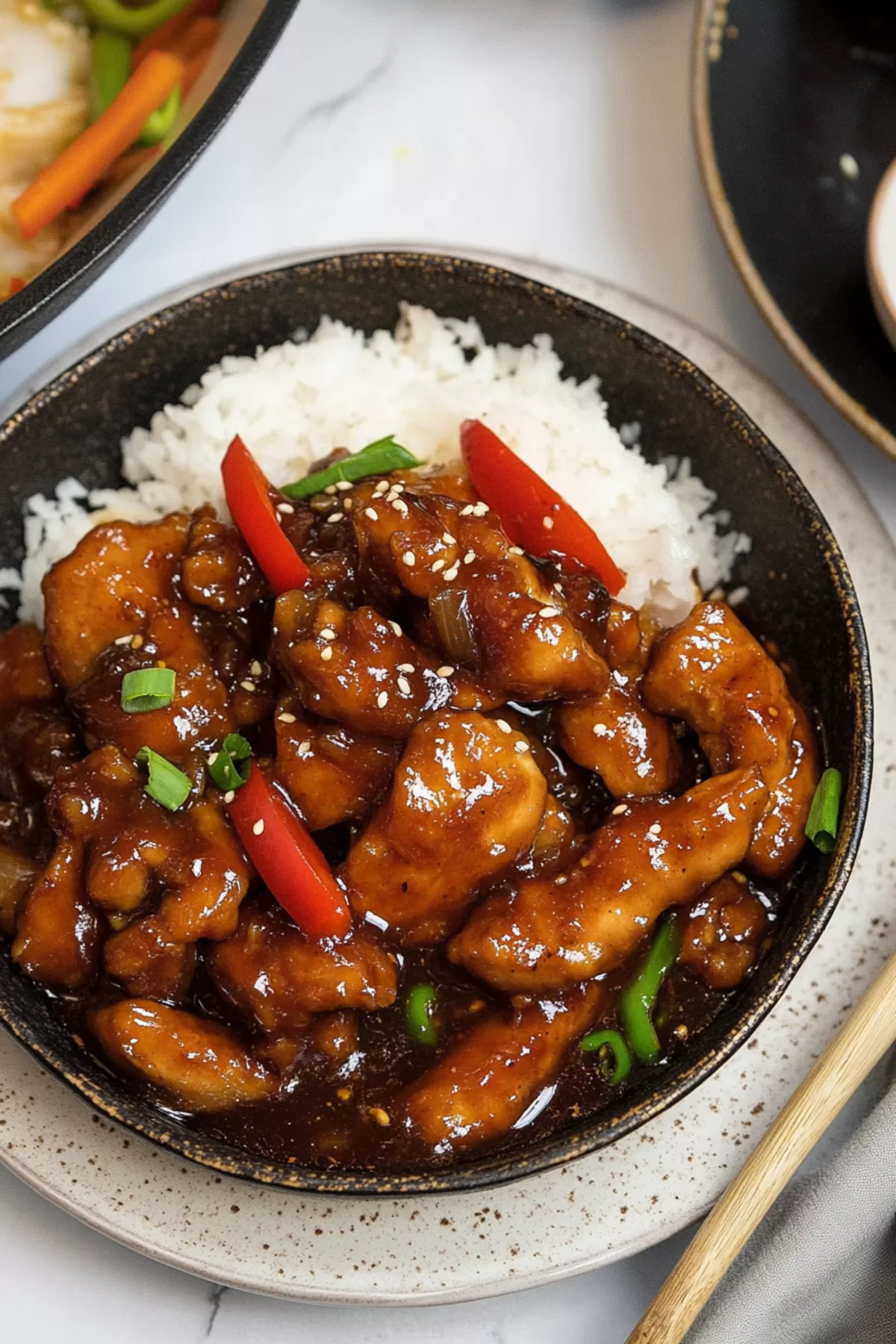 A plate of tender chicken paired with colorful bell peppers and broccoli in a flavorful glaze.