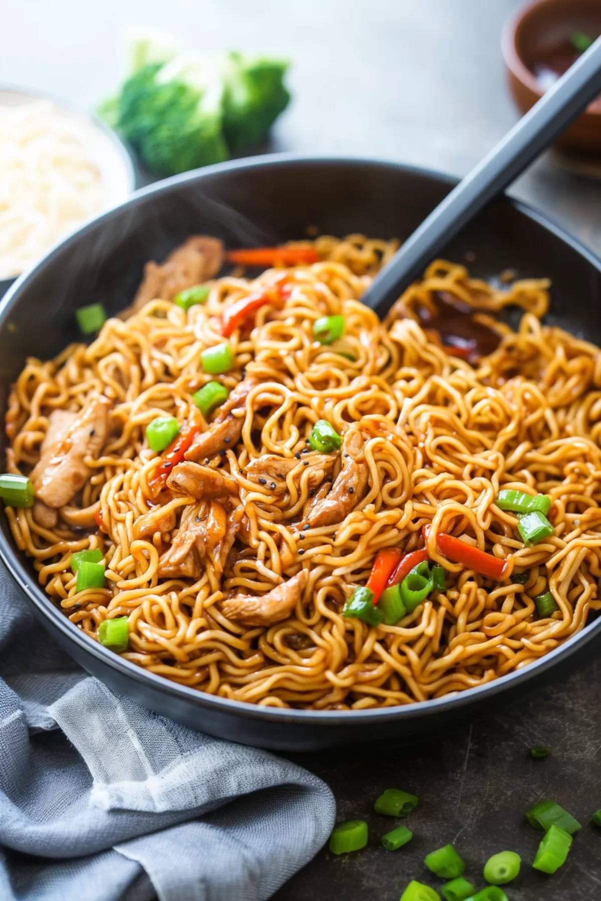 Ramen noodles served with juicy chicken and a rich, flavorful sauce in a rustic bowl.