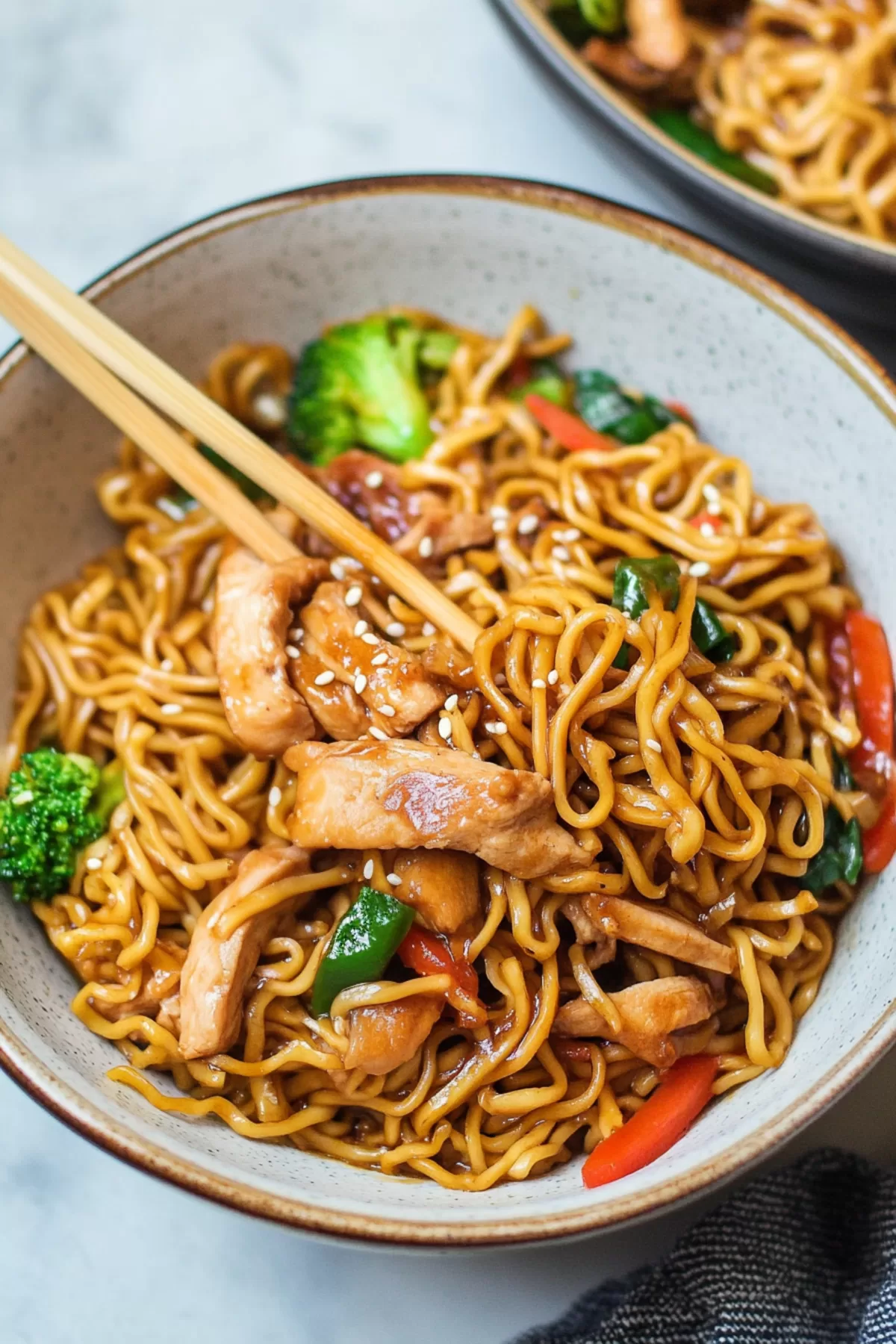 A comforting noodle dish with golden chicken slices and a medley of vibrant vegetables.