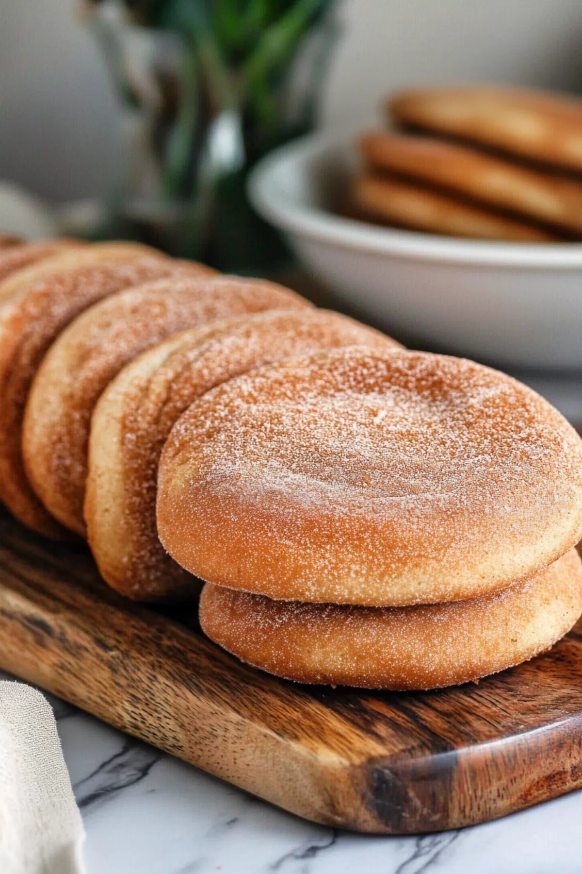 A rustic wooden board displaying a row of freshly baked churro cookies, ready to serve.