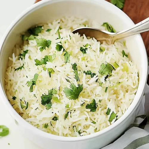 A spoonful of flavorful rice being served, highlighting its light and fluffy texture.