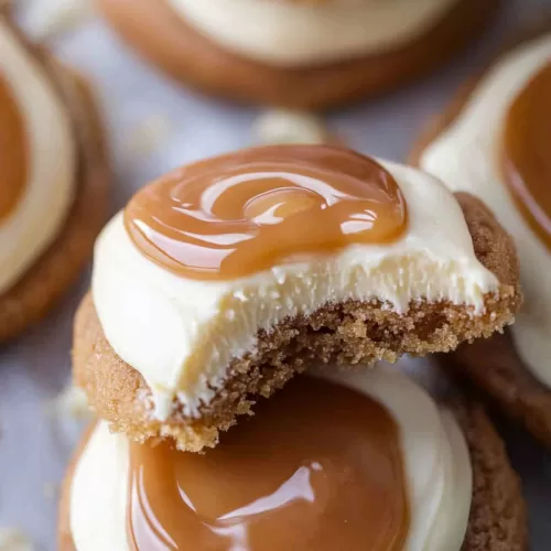 A stack of cookies showcasing layers of creamy frosting and caramel goodness.