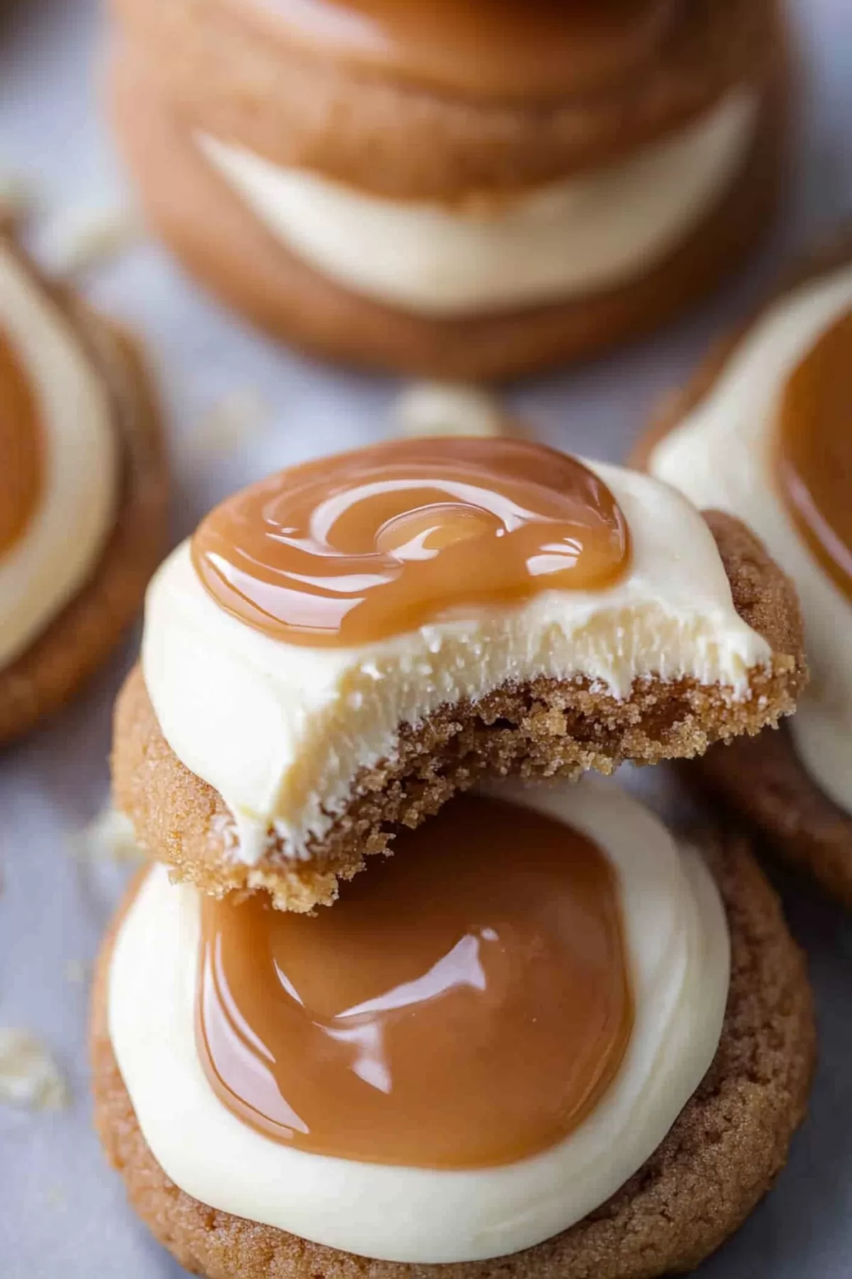 A stack of cookies showcasing layers of creamy frosting and caramel goodness.