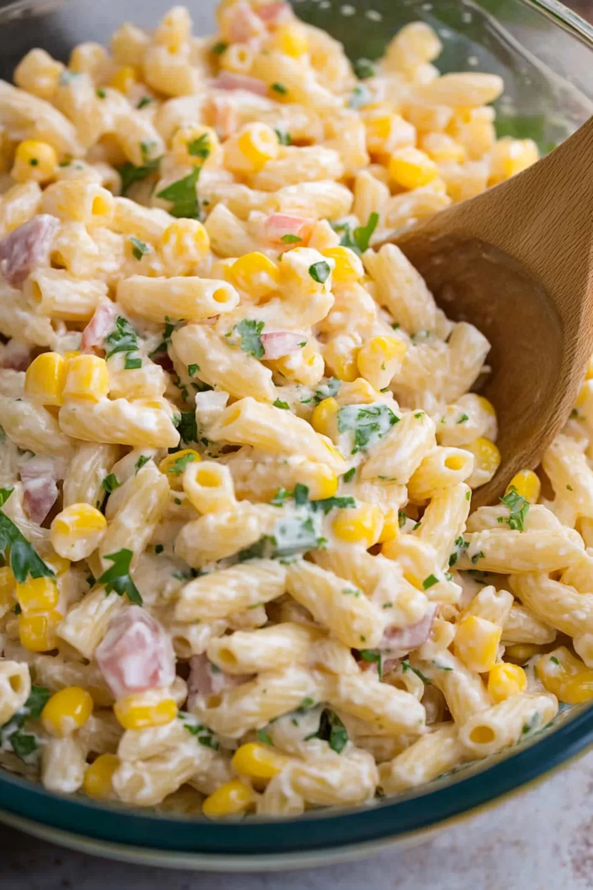 Close-up of a creamy and colorful salad with a light dressing.