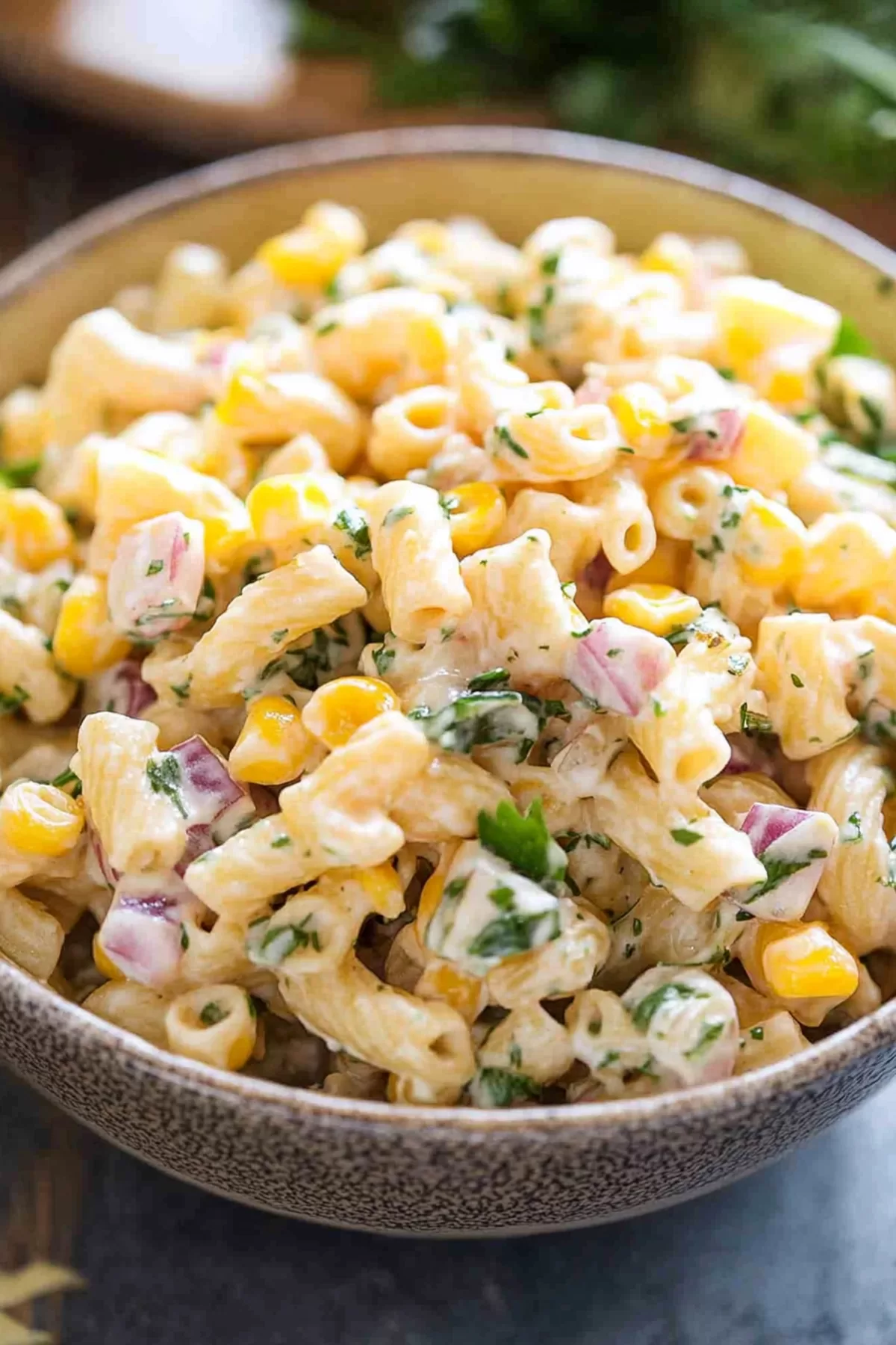 A vibrant bowl of mixed pasta and fresh vegetables, perfect for summer.