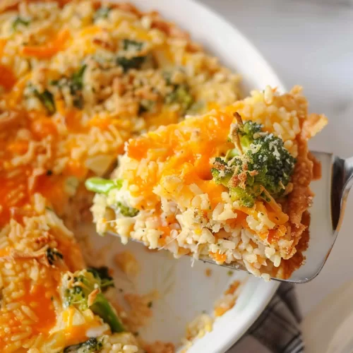 A slice of broccoli rice pie with a creamy, cheesy filling in a golden crust.