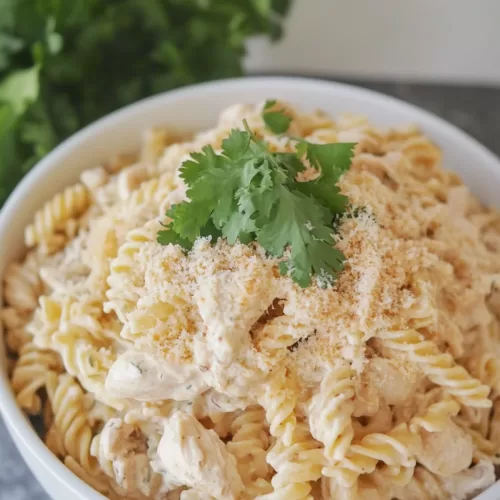 Creamy garlic parmesan chicken pasta served in a crockpot, perfect for a hearty family dinner.