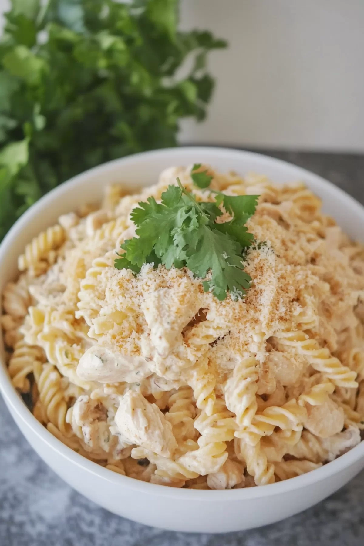 Creamy garlic parmesan chicken pasta served in a crockpot, perfect for a hearty family dinner.