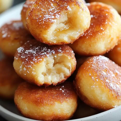 Soft and airy fritters with a hint of banana flavor, showcasing a bite-sized piece.