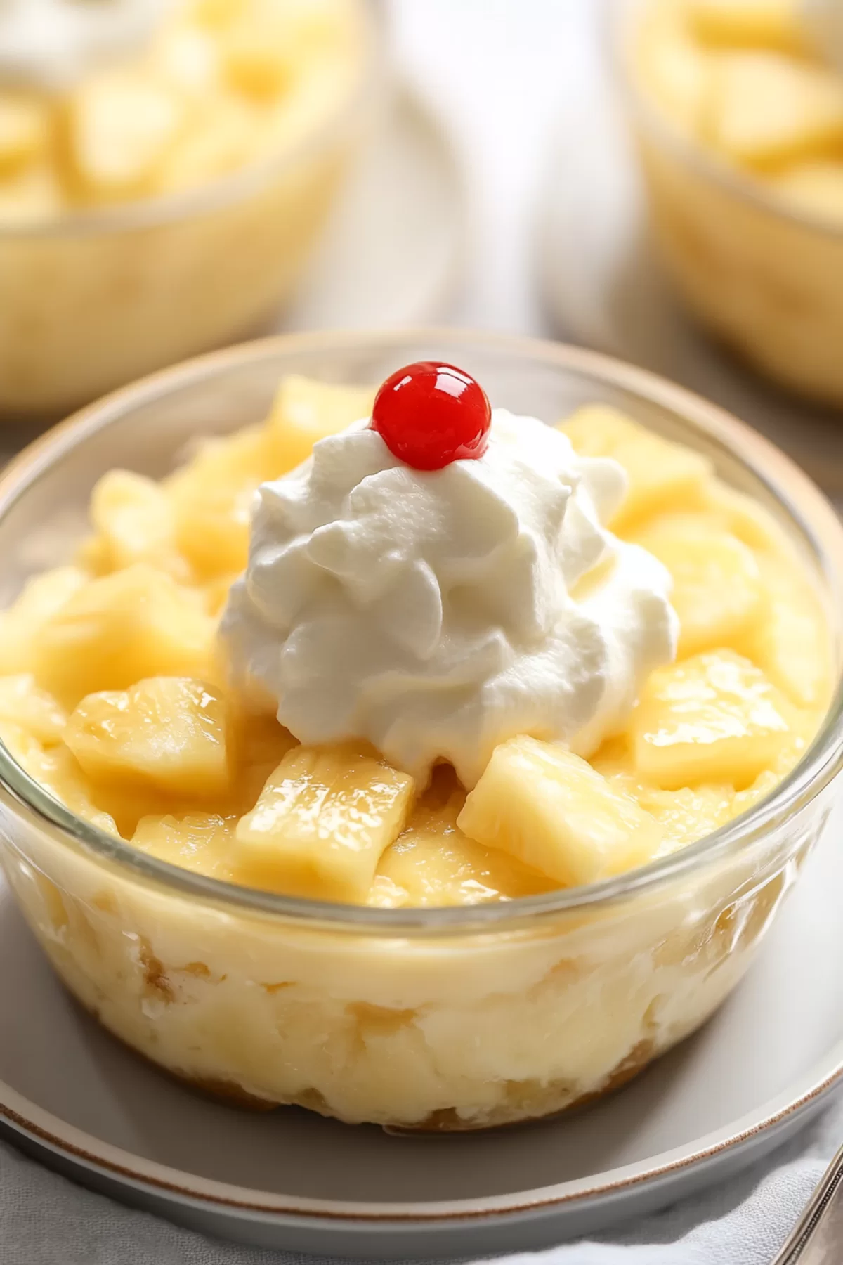 Light, fluffy dessert garnished with pineapple pieces, ready to serve.