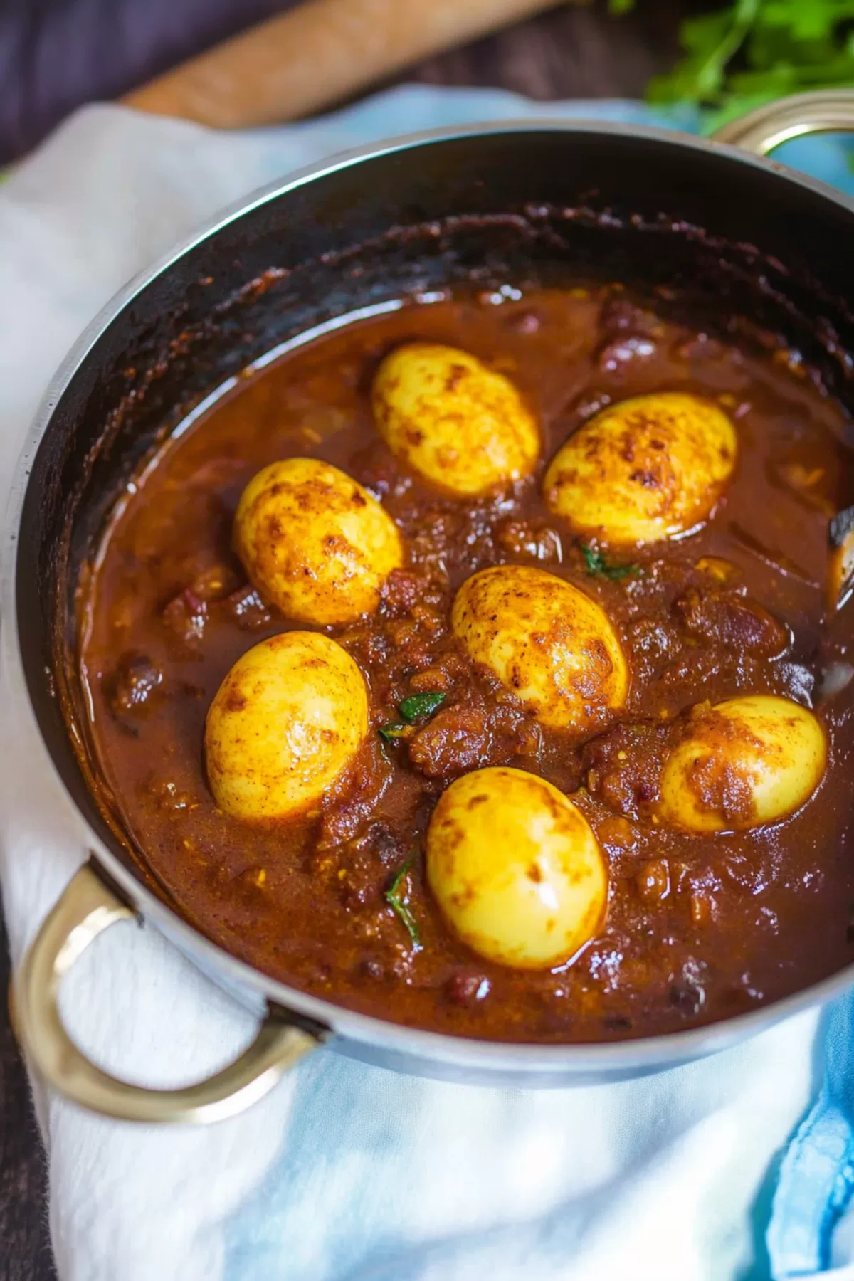 Warm and inviting curry served in a traditional dish with eggs nestled in the flavorful gravy.