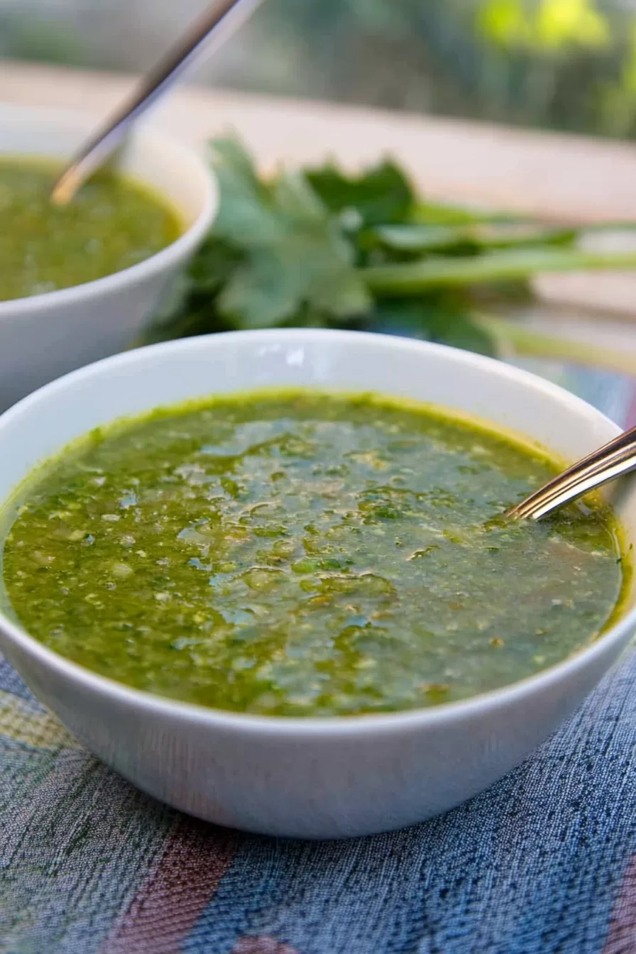 A rustic serving of soup in a ceramic bowl, showcasing its smooth, velvety texture and fresh garnish.