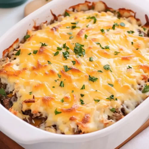 A casserole dish filled with a golden-brown, bubbling baked dish fresh out of the oven.