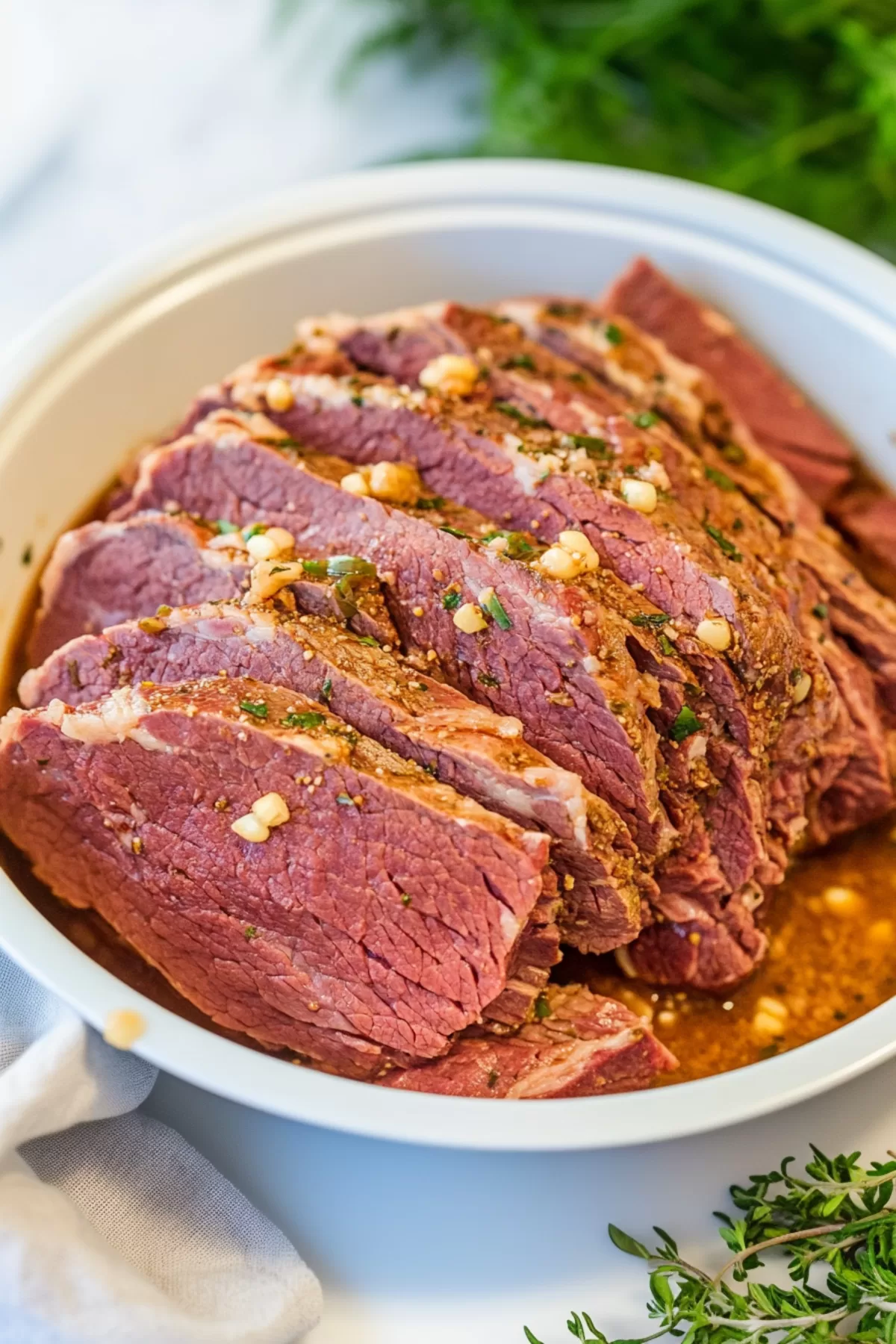 Uncooked corned beef seasoned with mustard seeds and herbs, ready to be cooked in the Instant Pot.