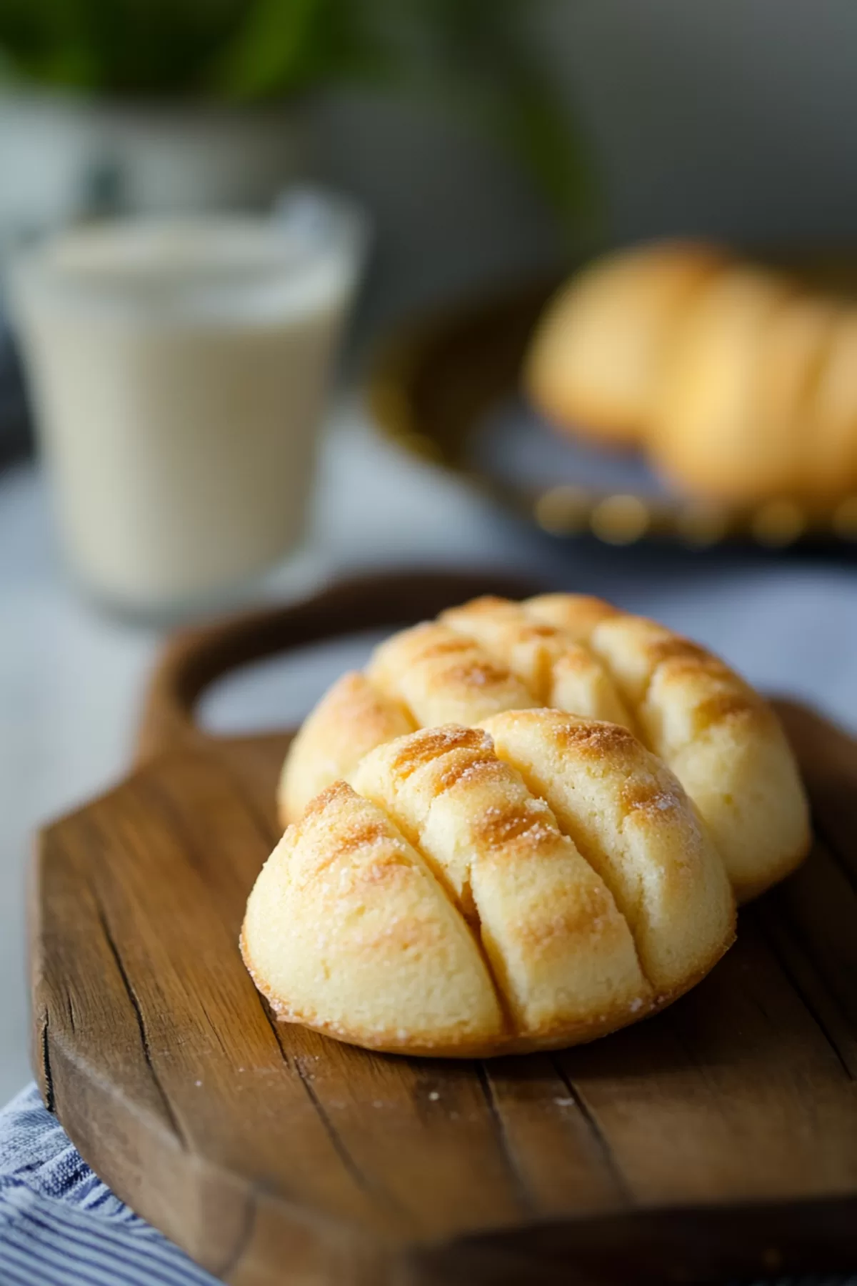 Soft, fluffy bread with a golden crust, served on a wooden board.