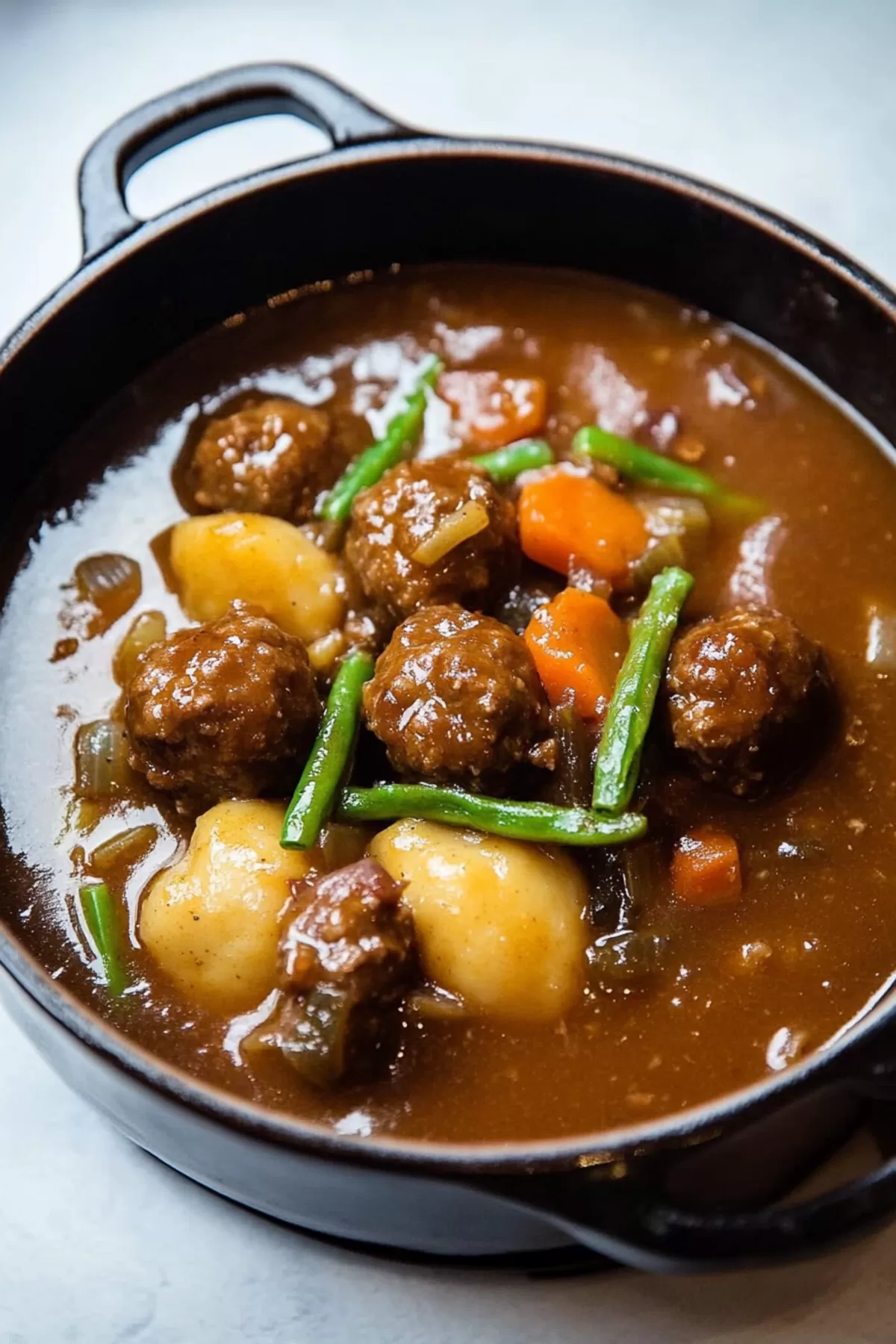 A rustic serving of stew with colorful vegetables and fresh herbs.