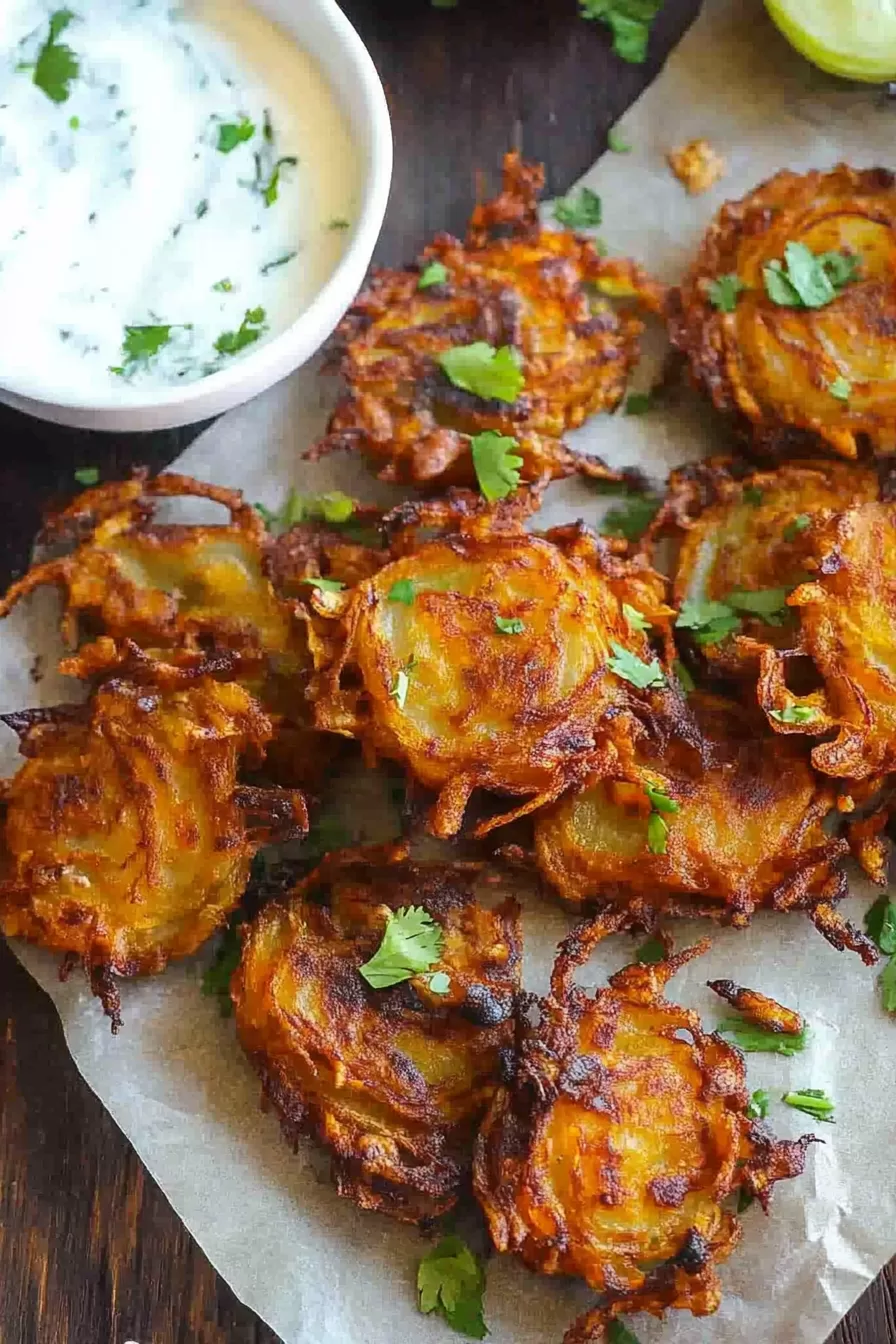 Freshly fried onion fritters with herbs, ready to enjoy as a tasty appetizer.