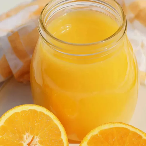 Glass jar of homemade orange drink with a creamy finish, capturing the essence of a creamsicle.