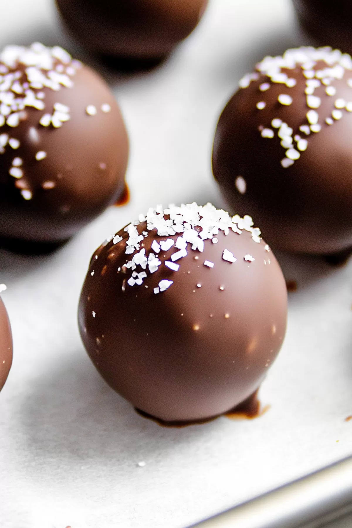 Close-up of bite-sized treats with a crunchy chocolate shell and a rich filling.