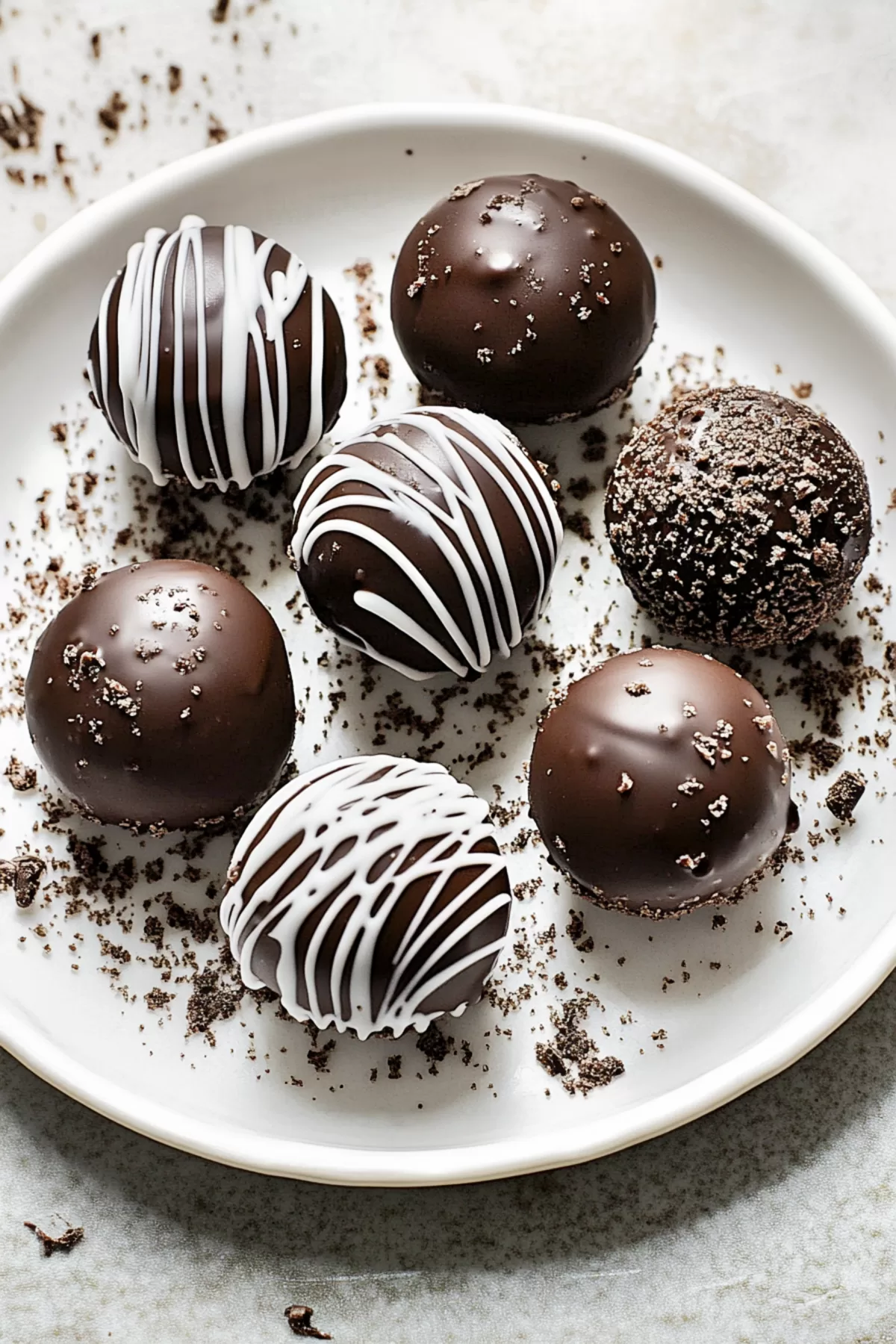 Assortment of chocolate truffles displayed on a plate, perfect for snacking.