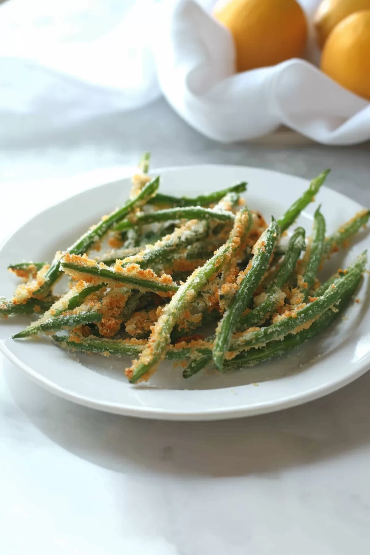 A handful of baked green bean fries served on a plate, garnished with a sprinkle of fresh parsley for a pop of color.