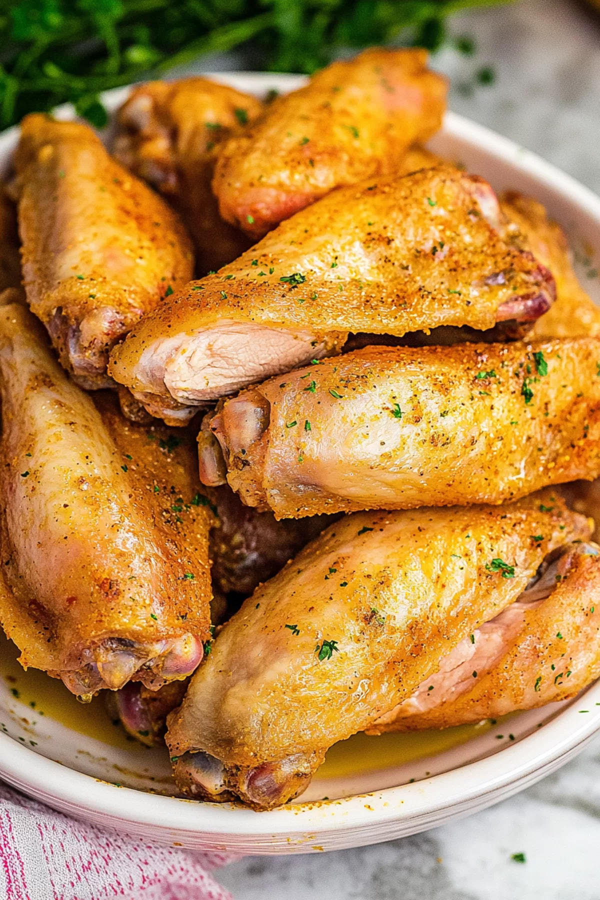 A family-style table setting featuring a dish of baked turkey wings as the centerpiece.