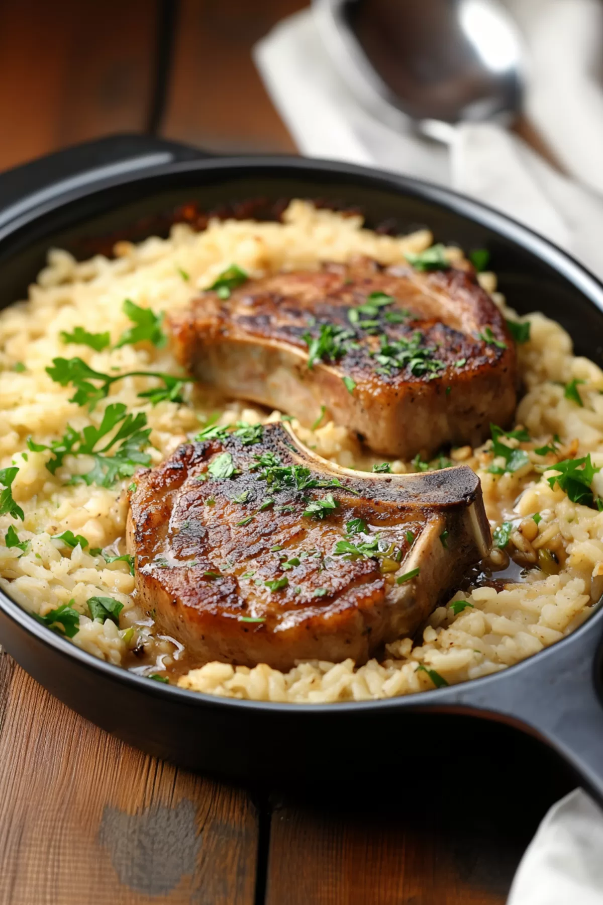 Casserole dish filled with succulent pork chops and perfectly cooked rice, ready to serve.