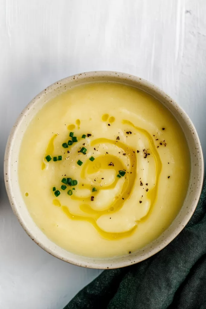 Close-up of a smooth and velvety soup with a rustic presentation.