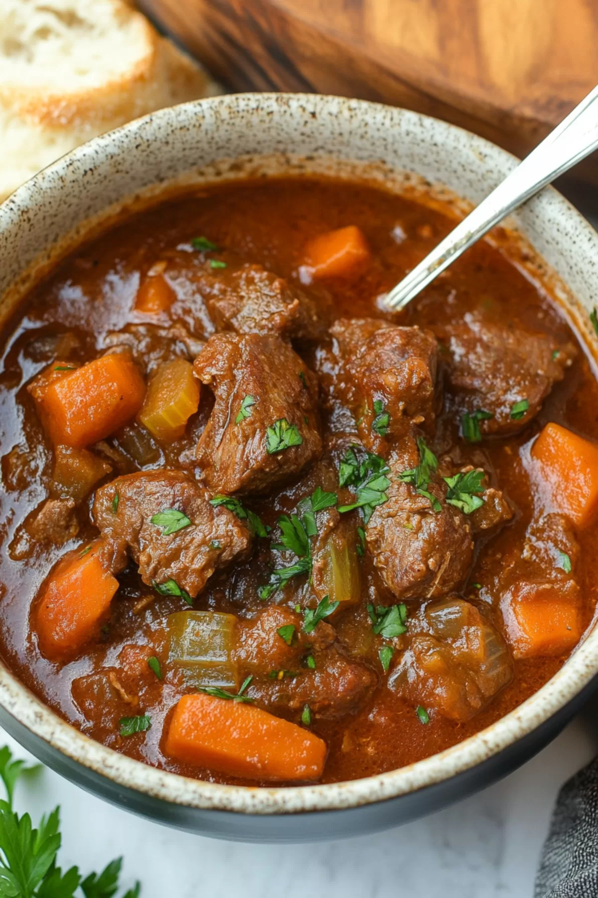 A hearty bowl of stew featuring tender meat and root vegetables in a rich sauce.