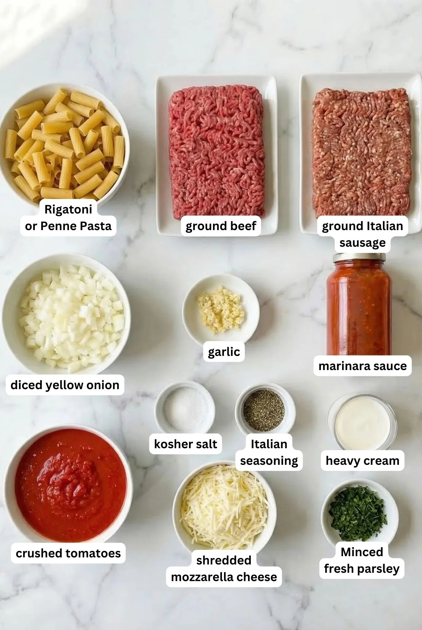 Ingredients for Baked Mostaccioli including pasta, ground beef, Italian sausage, onion, garlic, marinara sauce, crushed tomatoes, mozzarella cheese, heavy cream, and parsley