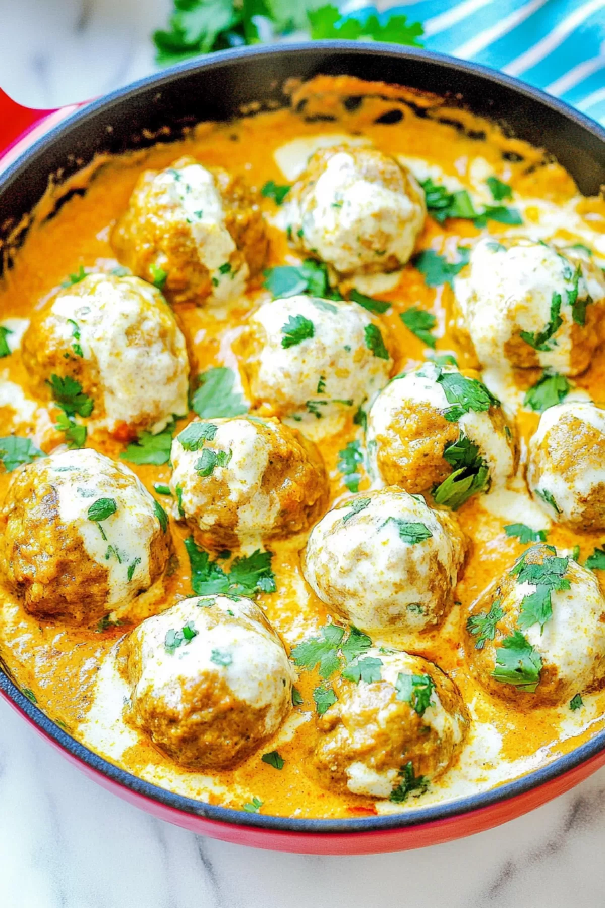 Golden-brown meatballs nestled in a flavorful curry sauce, ready to enjoy with rice or naan.