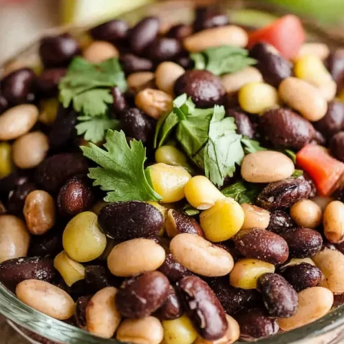 Cowboy caviar served in a bowl with a blend of beans, corn, and a hint of lime.