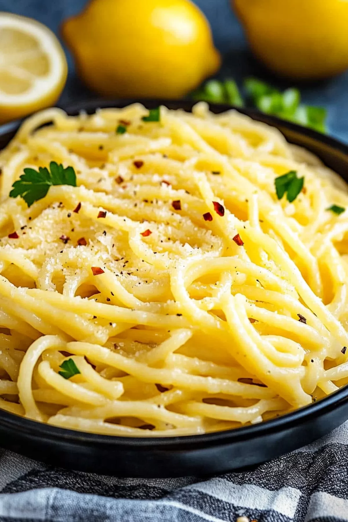 Golden pasta noodles glistening in a tangy lemon butter sauce with hints of fresh herbs.