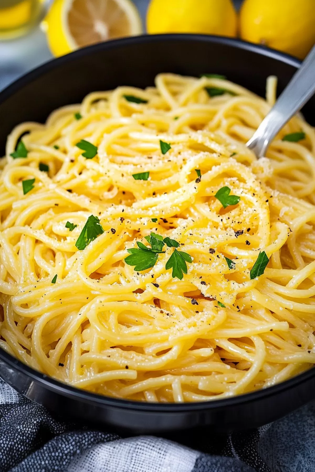 Elegant spaghetti swirled in a rich lemon butter sauce, enhanced with a sprinkle of Parmesan cheese.