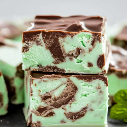 Close-up of creamy mint chocolate fudge with swirls of rich chocolate and a smooth, glossy finish.