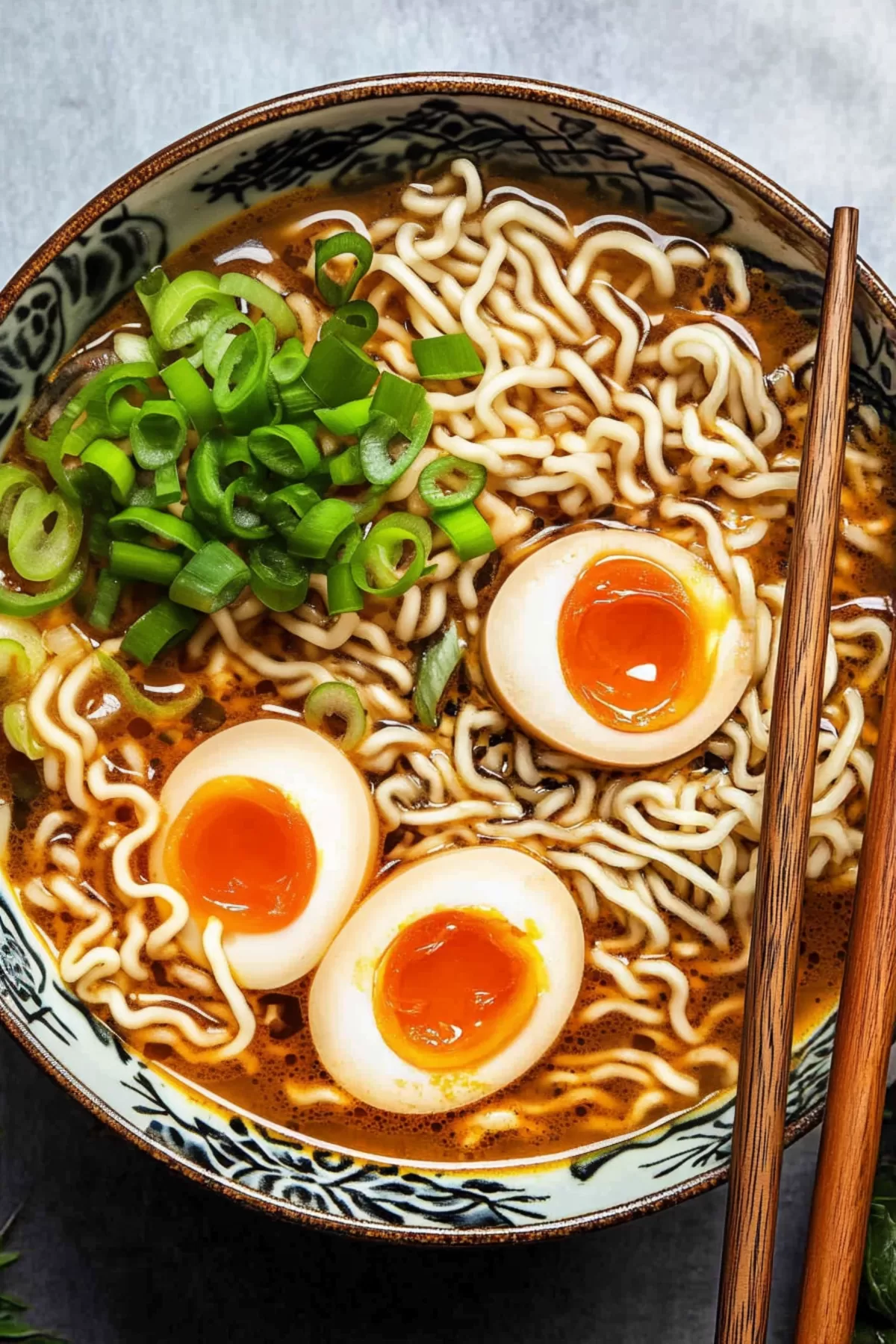 A hearty serving of miso ramen noodles in a rich broth, complemented by a marinated egg and scallions.