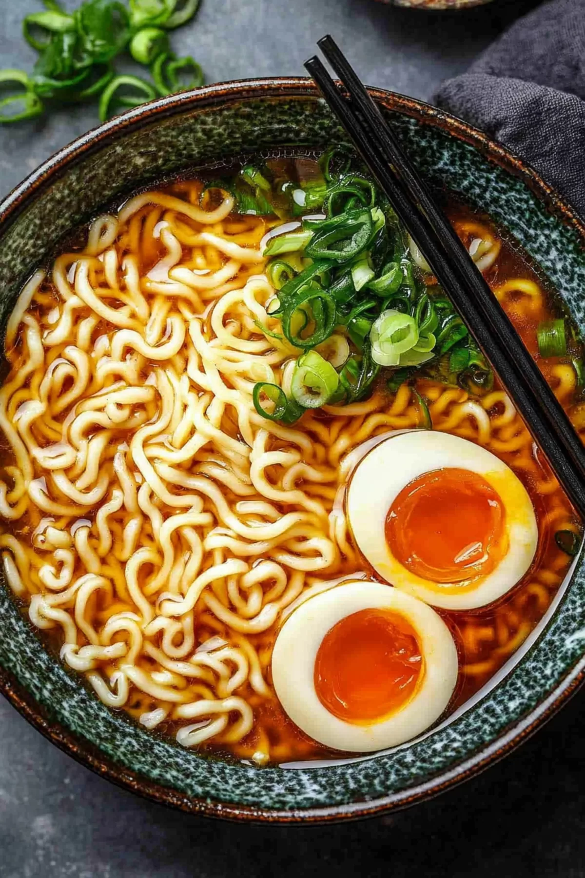 Elegant presentation of miso ramen with chopsticks resting on the bowl, featuring green onions and perfectly cooked noodles.