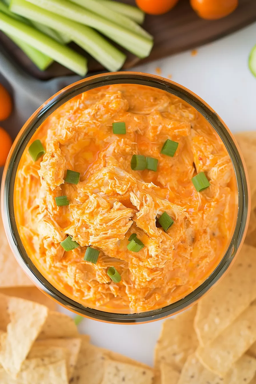 Buffalo Chicken Dip served with fresh veggie sticks, crackers, and chips, perfect for a game-day snack platter.