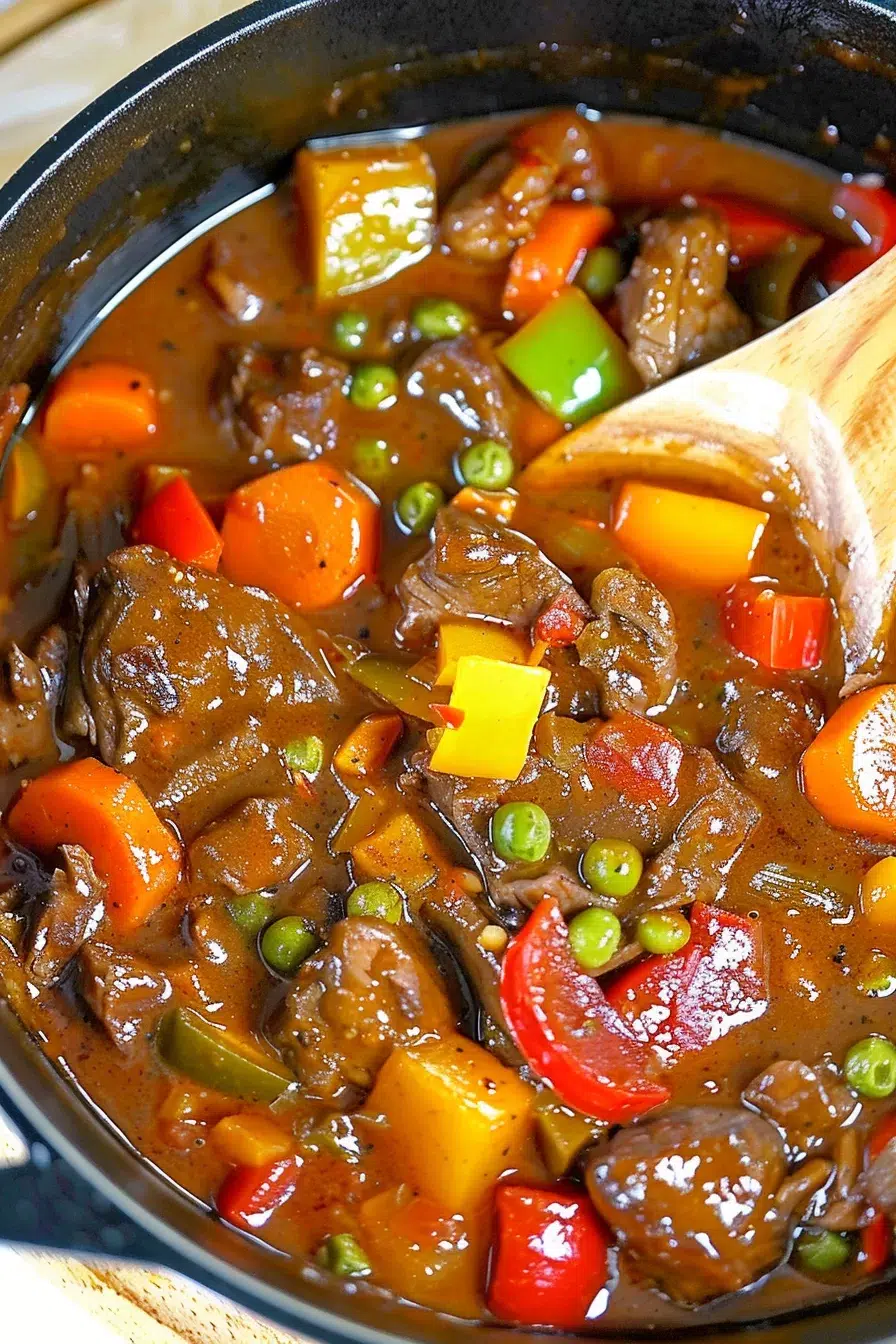 A vibrant stew featuring chunks of beef, peas, and bell peppers, perfect for a comforting meal.