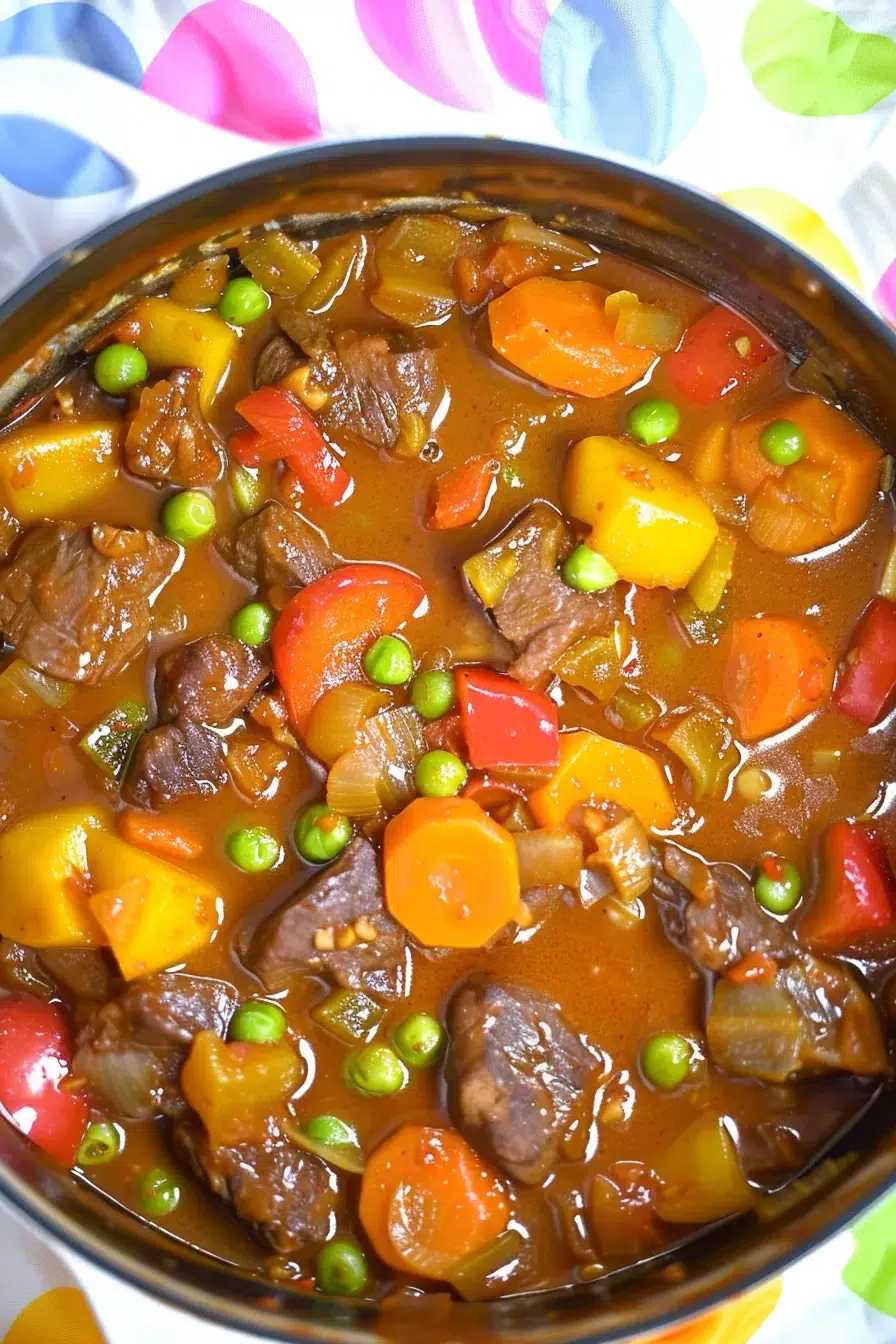 A pot of simmering stew with beef and vegetables, full of rich and bold flavors.