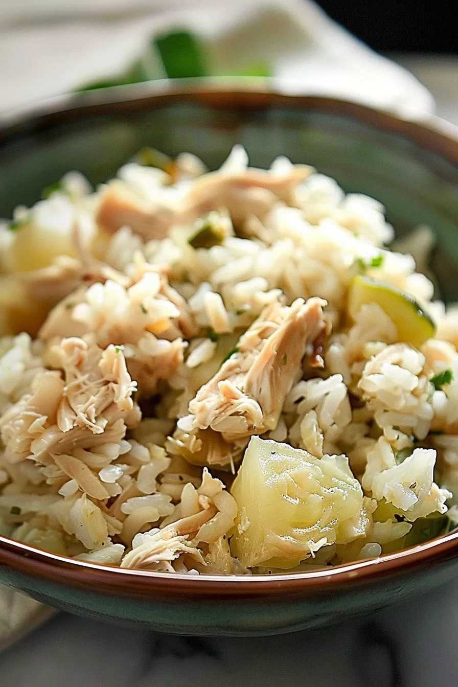 A homestyle bowl of chicken and rice with hints of celery and fresh herbs for a comforting meal.