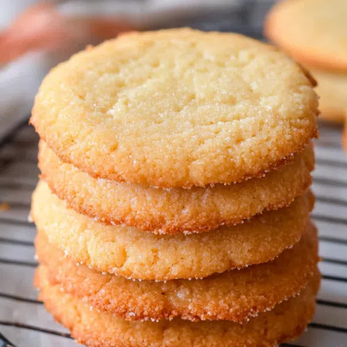 Close-up view of freshly baked cookies with a golden-brown color, arranged on a cooling rack.