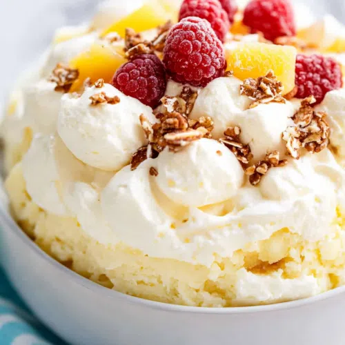 Overhead shot of a serving of pineapple fluff, topped with a sprinkle of crushed pineapple.