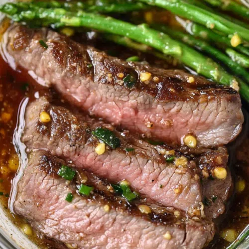 Grilled steak slices arranged on a serving platter, glistening with a savory marinade.
