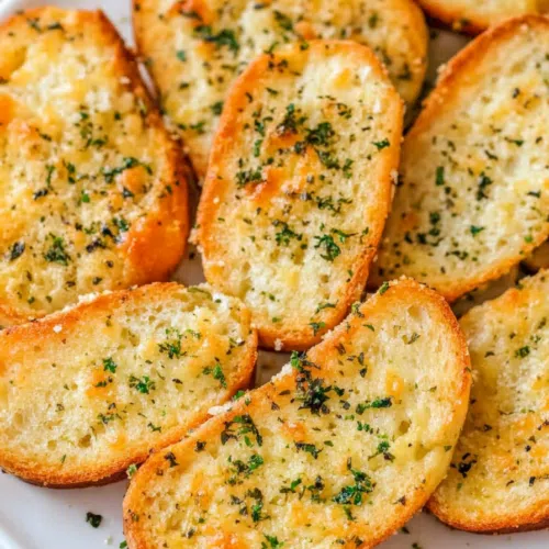 Close-up of a slice of garlic cheese bread showing the gooey melted cheese and crispy edges.